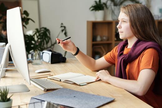 girl-holding-pencil-while-looking-at-imac-4144223.jpg